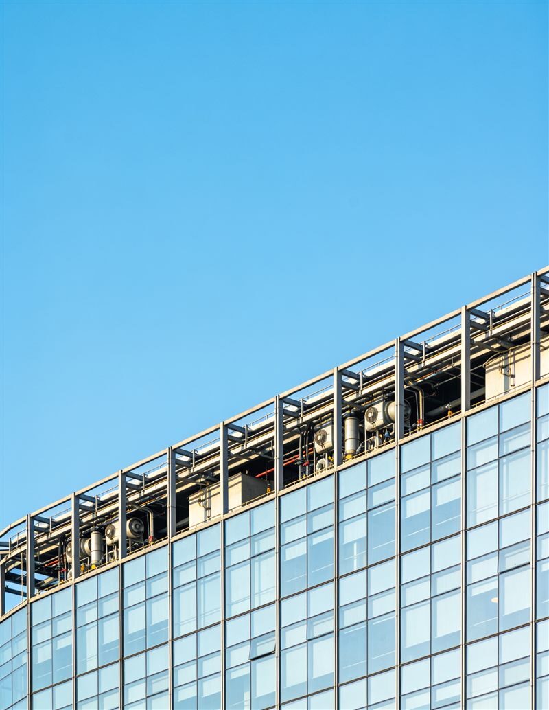 A commercial building facade with rooftop plant, typical of MEP and design work