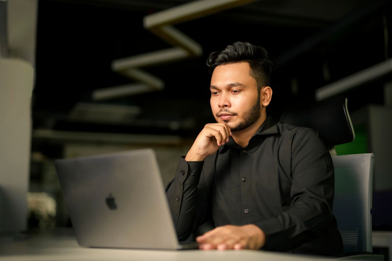 Electrical consultant reviewing a lightning risk assessment on a laptop