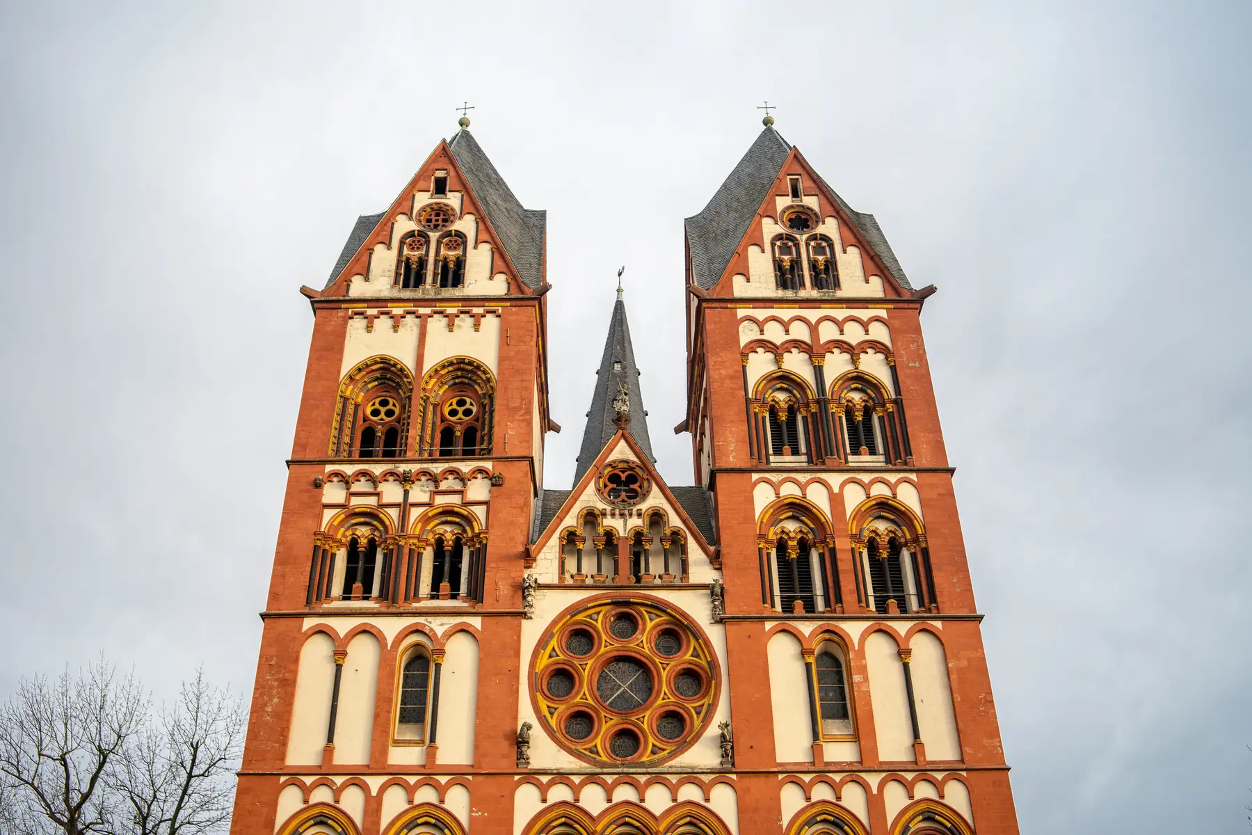A gothic cathedral under a stormy sky, an irreplaceable heritage structure needing lightning protection
