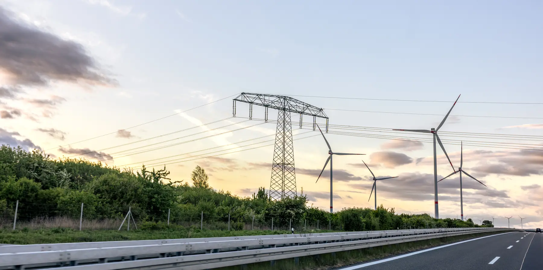 Wind turbines and power lines across an open site, a large collection area for lightning strikes